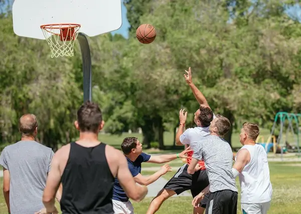 Boys and men playing basketball