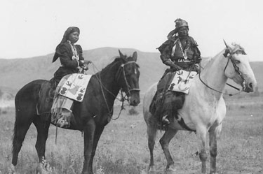 Two Native Americans sitting on horses