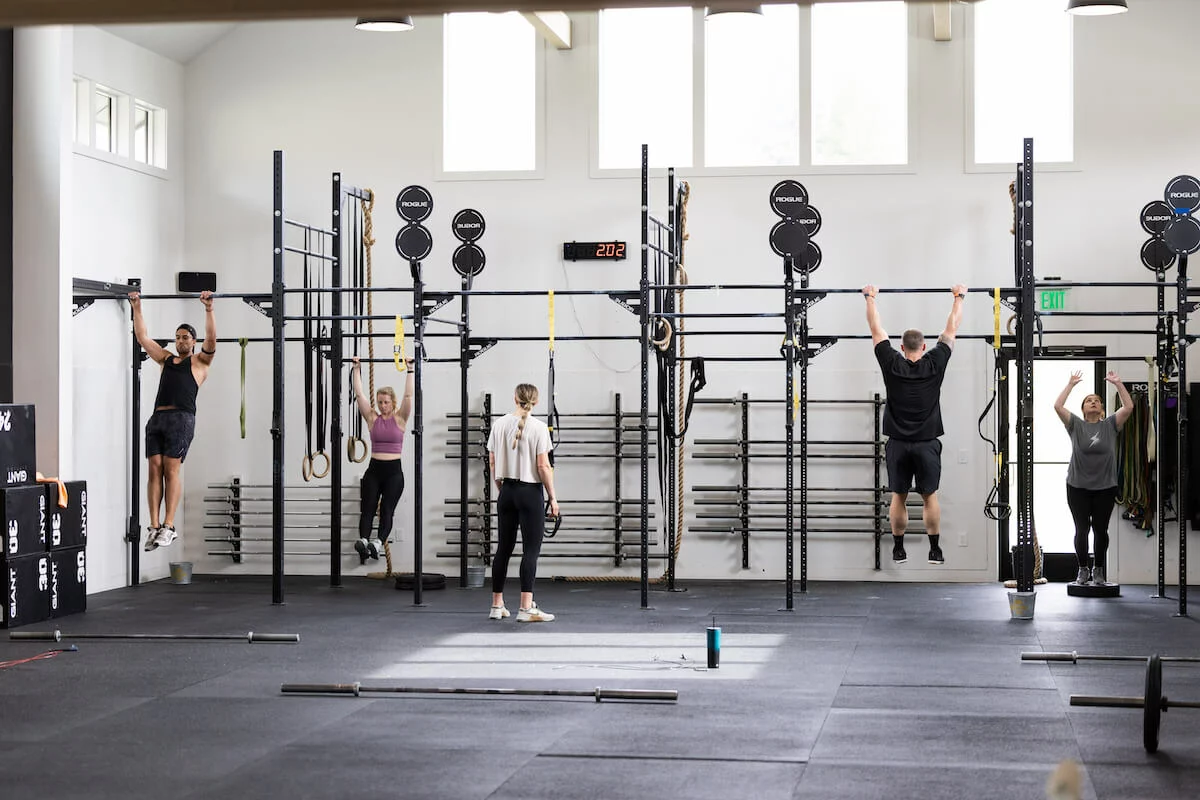 Multiple people working out at a gym