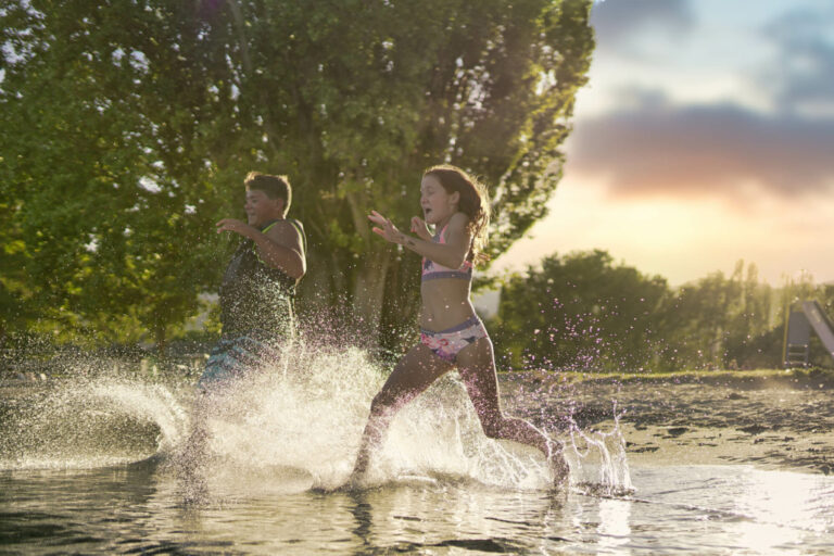 Kids running through the water